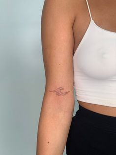 a woman with a small tattoo on her arm