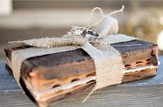 an old book is wrapped in burlap and tied with twine on top