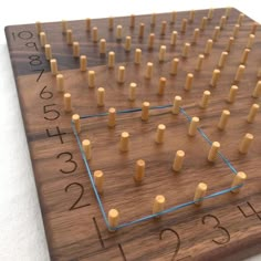 a wooden board game with numbers on it