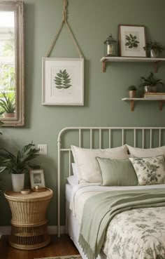 a bedroom with green walls and white bedding, potted plants on the wall