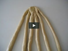 the video shows how to make long, thin breadsticks with wax on them