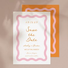 an orange and white save the date card on top of a pink and yellow envelope