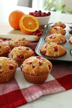 muffins with cranberries and orange on a table