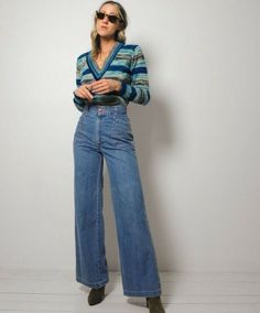 Amazing vintage 70s flared jeans. Lighter weight, soft denim. Ultra high waist with zipper and button closure. Stitched pockets on front and back. Flared bellbottom shape. Please see measurements. Original seller's try on photo included. Asking what I paid. Waist : 12.5" Length : 43.5" Inseam : 32" Rise : 12" Hips : 18" Fabric : cotton In excellent condition - no flaws to note. Model is 5'7" / bust: 34" / waist: 25" / hips: 37" 70s Inspired Wide Leg Flare Jeans For Fall, Retro High Waist Flare Jeans For Spring, Retro High Waist Flare Jeans For Fall, 70s Inspired High Rise Fitted Jeans, 70s Inspired Wide Leg Jeans For Spring, Retro High Waist Jeans For Fall, 70s Inspired Fitted Straight Leg Jeans, 70s Inspired Denim Jeans For Spring, 70s Inspired Spring Denim Jeans