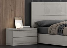 a bedroom with a bed, night stand and two nightstands on either side of the bed