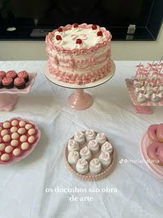 a table topped with lots of cakes and desserts