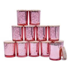 a stack of pink glass jars sitting next to each other