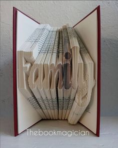 an open book with pages folded into the word love