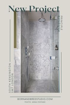 a bathroom with marble walls and flooring next to a walk in shower, surrounded by glass doors