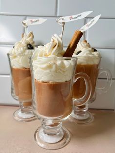 three glasses filled with hot chocolate and whipped cream