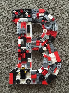 the letter b is made out of legos and has been placed on the floor