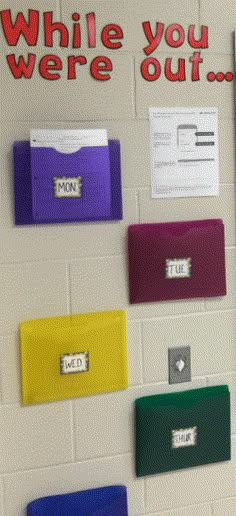 there are many mailboxs on the wall in this school room that says, while you were out