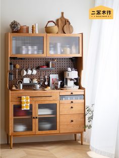 a wooden cabinet with glass doors and shelves on it's sides, filled with dishes and utensils