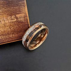 a wedding ring is shown on top of a wooden box with the words pillar styles written below it