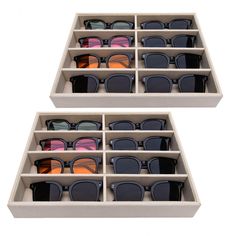 two boxes filled with pairs of sunglasses on top of each other