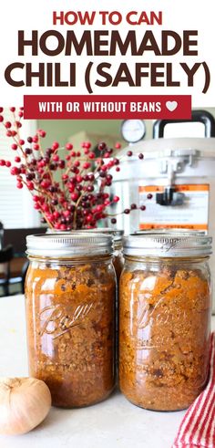 two jars filled with homemade chili sauce on top of a counter next to an onion