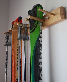 there are many skis and snowboards hanging on the wall