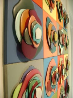 the colorful wall is decorated with different shapes and sizes