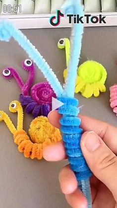 a person is holding up some colorful crochet items to make them look like they are