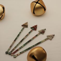 several different types of metal objects on a white surface with gold colored handles and knobs