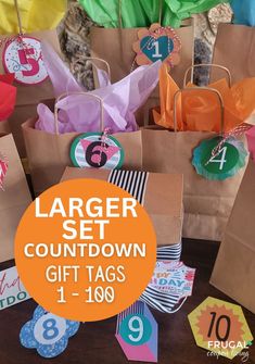 there are bags with numbers on them and tags attached to them that say, larger set countdown gift tags 1 - 108