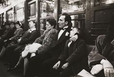 many people are sitting on a subway train