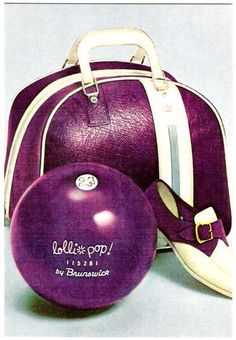 a purple bowling ball sitting next to a bag