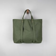 Woodbine Tote in Olive Heavyweight Canvas – J. Stark – Made in USA Practical Weekender Tote Bag With Pockets, Green Everyday Satchel With Pockets, Everyday Bucket Canvas Bag With Handles, Everyday Large Capacity Waxed Canvas Bag, Green Waxed Canvas Bags With Pockets, Eco-friendly Everyday Waxed Canvas Bag, Practical Everyday Tote Weekender Bag, Practical Everyday Weekender Bag Tote, Practical Spacious Canvas Bag For Everyday Use