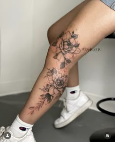 a woman's leg with flowers on it