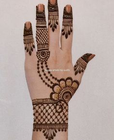 hendi design on the palm of a woman's hand, with intricate details