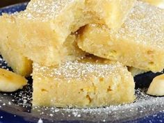 several pieces of cake sitting on top of a blue plate covered in powdered sugar