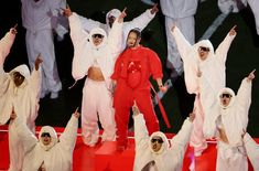 a group of people standing on top of a red and white platform with their arms in the air