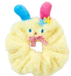 a yellow stuffed animal with blue eyes and pink ears, has a bow on it's head