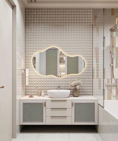 a bathroom with a sink, mirror and bathtub in the middle of the room