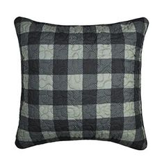 a black and white checkered pillow on a white background