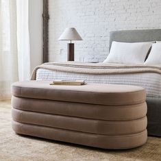 an inflatable bed sits on the floor next to a lamp