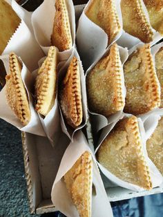 there are many pastries in the box on the table and ready to be eaten