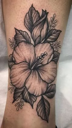 a black and white flower tattoo on the leg