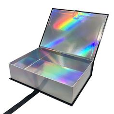 an open box with holographics on the lid and black ribbon around it