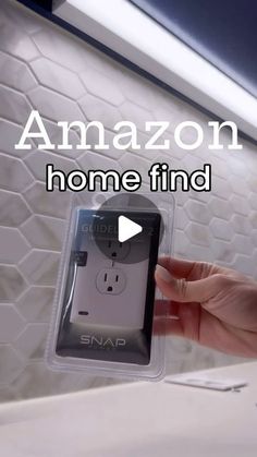 a person holding an amazon smart phone in their hand with the caption, home find