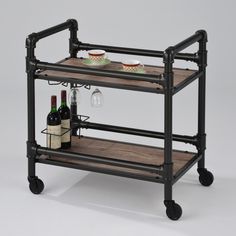 a wine rack with two bottles and glasses on it, sitting next to a bottle of wine