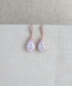 "Lovely simple rose gold earrings with amazing sparkle I created using Swarovski Pure Brilliance cubic zirconia components. - Earrings dangle 1-1/4\" - Teardrop measures 14mm x 9mm PLEASE ALLOW APPROX 3 BUSINESS DAYS FOR COMPLETION BEFORE SHIPPING. Matching necklace: https://www.etsy.com/listing/180333879/rose-gold-bridal-necklace-crystal Feel free to contact me with any questions ! Thank you for visiting ! Treasures570 Back to main page of Treasures570 for more beautiful designs https://www.ets Rose Gold Prong Setting Bridal Drop Earrings, Rose Gold Drop Bridal Earrings With Prong Setting, Rose Gold Drop Earrings With Prong Setting For Bridal, Rose Gold Drop Earrings With Prong Setting For Brides, Dainty Wedding Earrings, Rose Gold Chandelier Earrings, Drop Bridal Earrings, Long Crystal Earrings, Teardrop Bridal Earrings