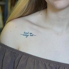 a woman with a tattoo on her shoulder saying read up, worry out