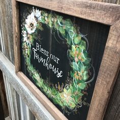 a wooden frame with a wreath painted on it