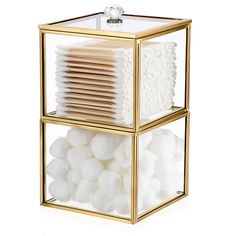 a glass box filled with lots of white cotton in front of a white wall and floor