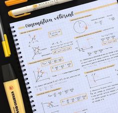 a notebook with some writing on it next to two pens and a calculator