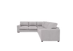 a white sectional couch sitting on top of a white floor next to a wooden table