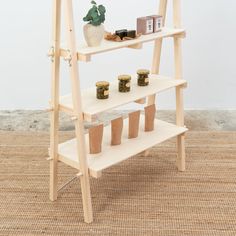 a wooden shelf with jars on it and a potted plant