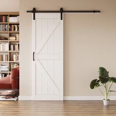 a living room with an open door and bookshelf in the background, next to a potted plant