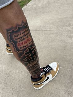 a man with a cross tattoo on his leg